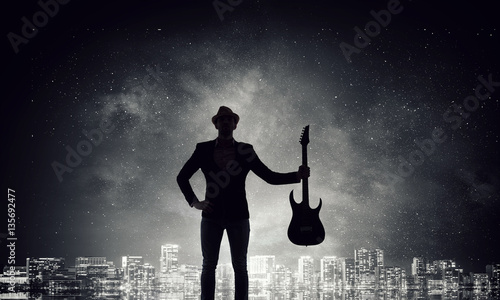 Elegant guitarist silhouette . Mixed media