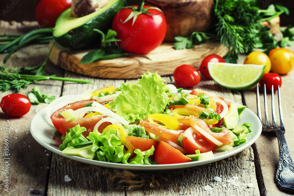 Salad with avocado, salmon, lettuce, onions and peppers on a pla Salad with avocado, salmon, lettuce, onions and peppers on a pla