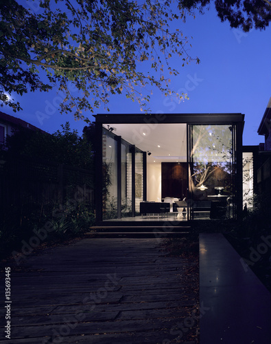 Exterior of a house seen at night with garden