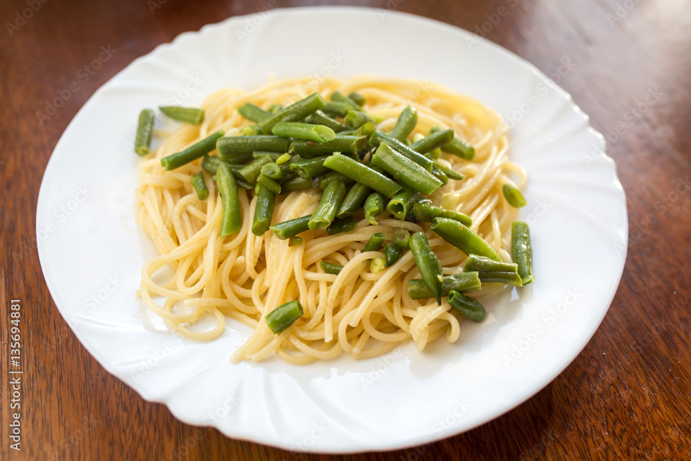Green beans and spaghetti on a plate. Healthy food