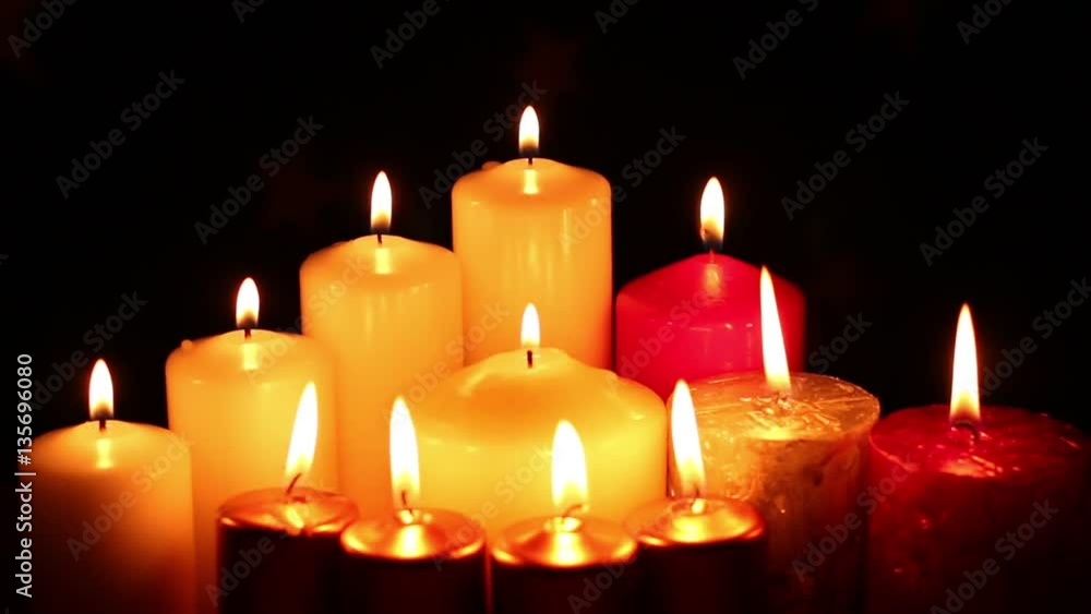 Many different multicolored candles lit out of focus and blur. Gradually appears sharpness candle burn fire. Romantic or RIP darkness template Many different multicolored candles lit out of focus and blur. Gradually appears sharpness candle burn fire. Romantic or RIP darkness template