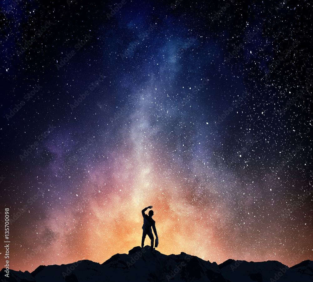 Fototapeta premium Businessman against starry sky . Mixed media