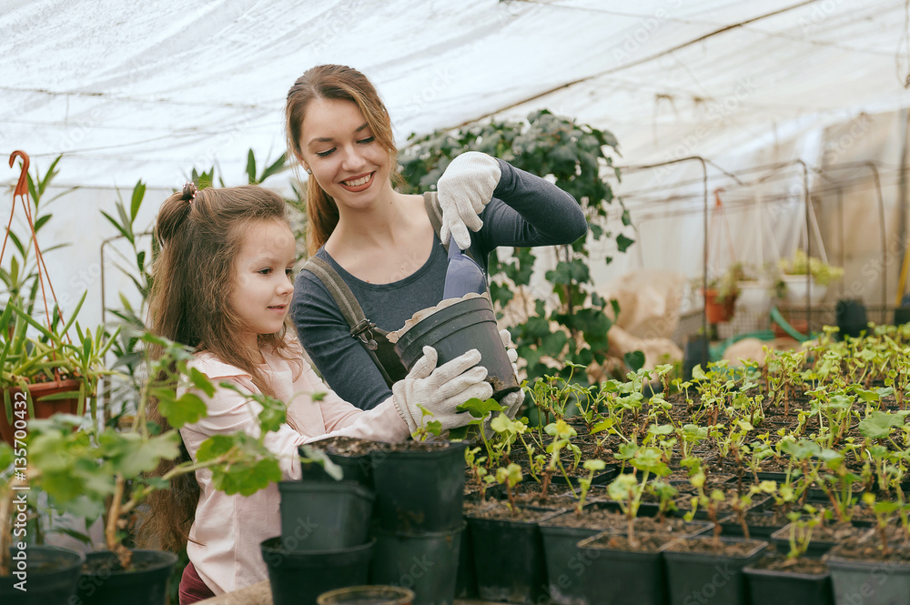 mother and daughter taking care of plants mother and daughter taking care of plants