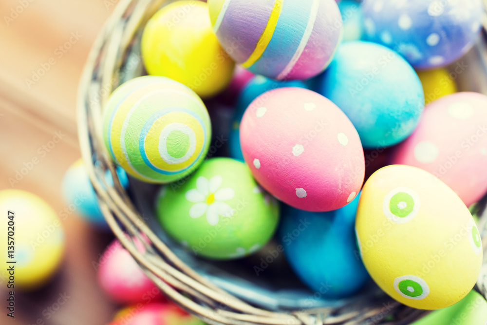 close up of colored easter eggs in basket close up of colored easter eggs in basket