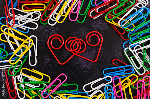 Colored paper clips isolated on dark background