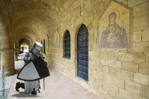 Medieval knight praying in cloistered in Filerimos Monastery in Rhodes Island built by the Knights of Saint John, Greece photo