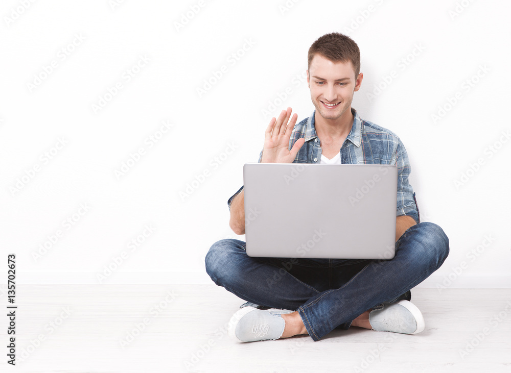 Young couple talking to each other via online video chat. Handsome man using a laptop for business and entertainment Young couple talking to each other via online video chat. Handsome man using a laptop for business and entertainment