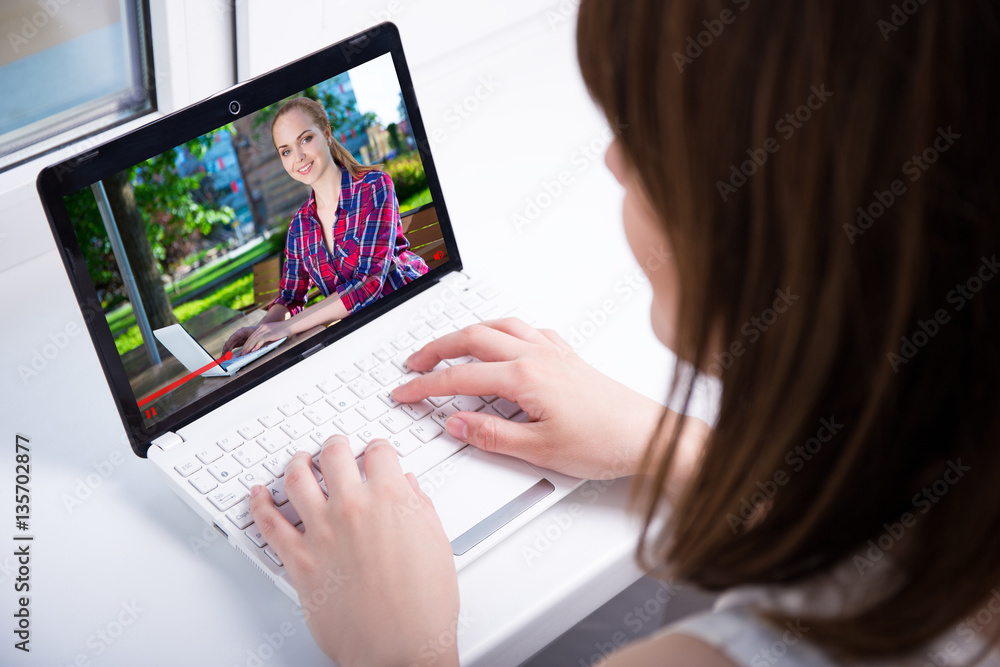 video blog concept - back view of young woman watching business video blog concept - back view of young woman watching business