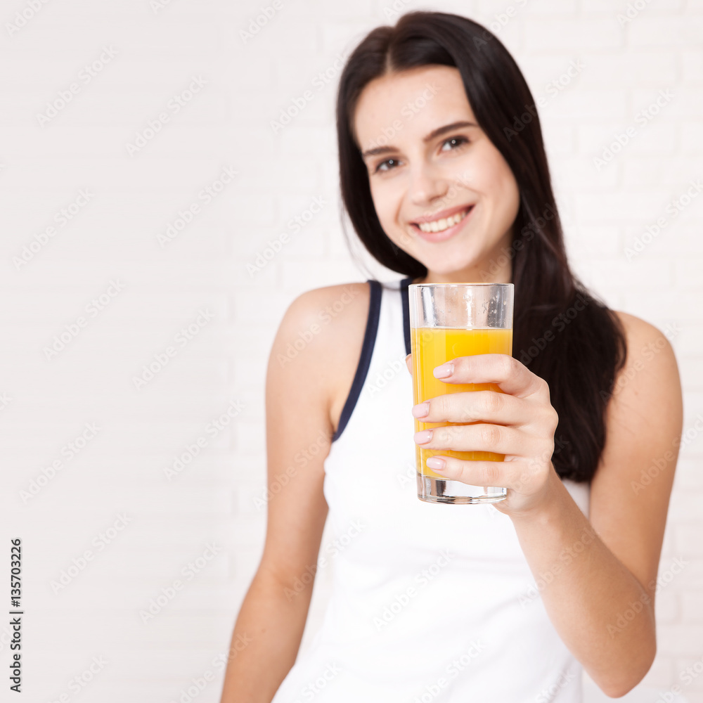 Closeup photo of sexy young woman drinking orange juice Closeup photo of sexy young woman drinking orange juice