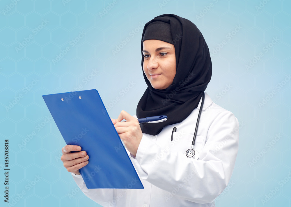 muslim female doctor in hijab with clipboard muslim female doctor in hijab with clipboard