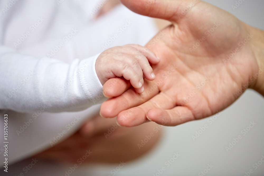 close up of mother and newborn baby hands close up of mother and newborn baby hands