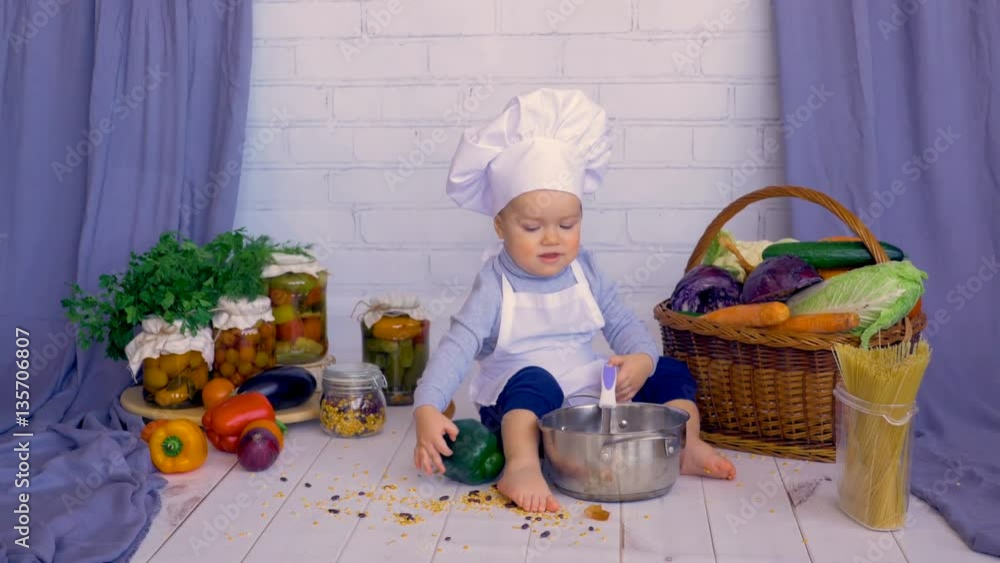 Cute little baby child in the kitchen cooking in pan. 4K. Cute little baby child in the kitchen cooking in pan. 4K.