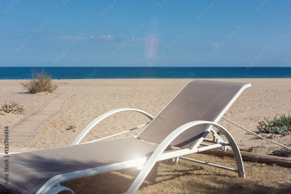 White sunbeds on your private beach waiting for you White sunbeds on your private beach waiting for you