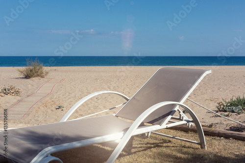 White sunbeds on your private beach waiting for you