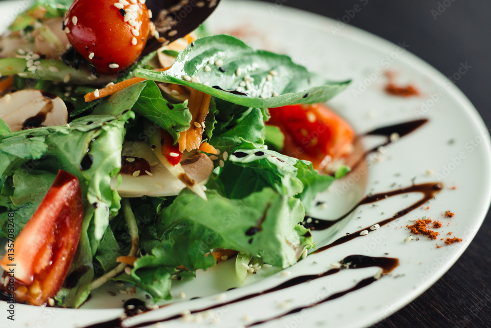 Salad with greens and mushrooms on a white plate Stock Photo | Adobe Stock