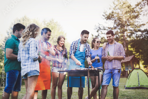 Happy people having camping and having bbq party #135708225