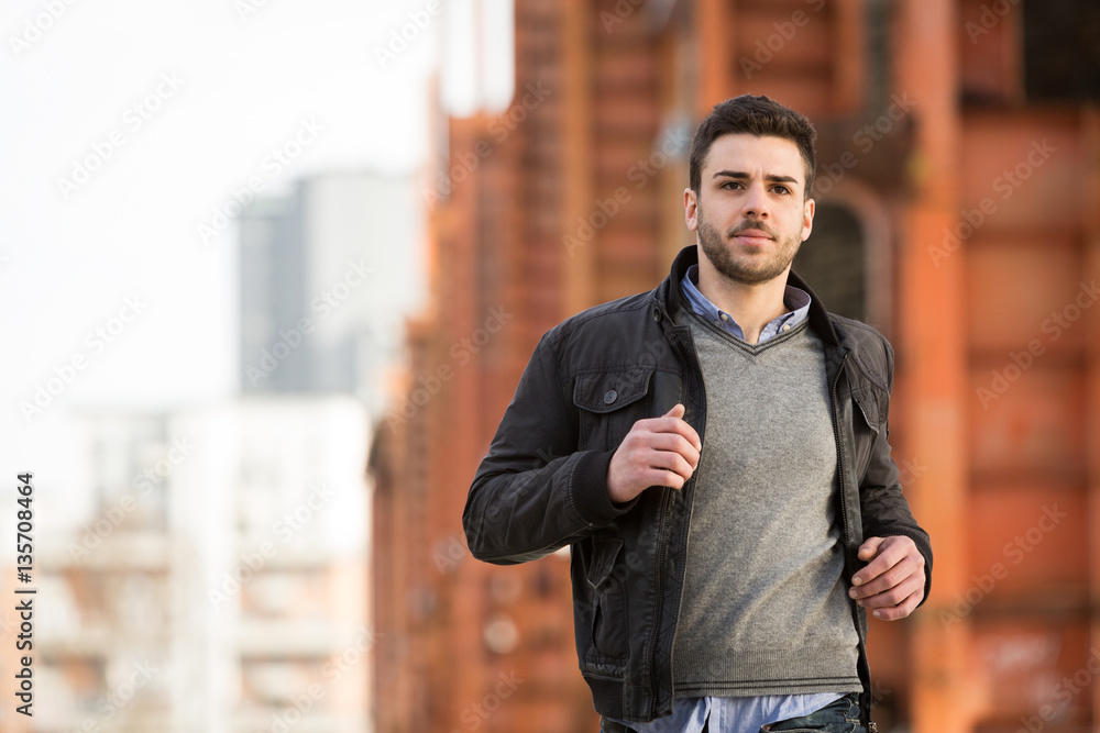 casual caucasian man running in urban city casual caucasian man running in urban city