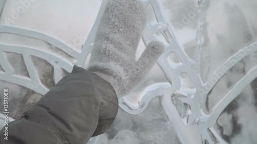 young woman smiling at the ice sculptures, winter gloves close up photo