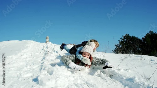 Wallpaper Mural family sleigh ride through the snow, happy mother and son moves down on a sled, sledding down the hills, fast descent on a snowy slope in woods, fun winter holidays, fun winter Torontodigital.ca