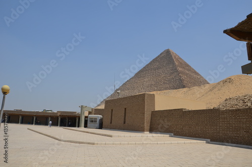 Pyramid in sand dust under gray clouds