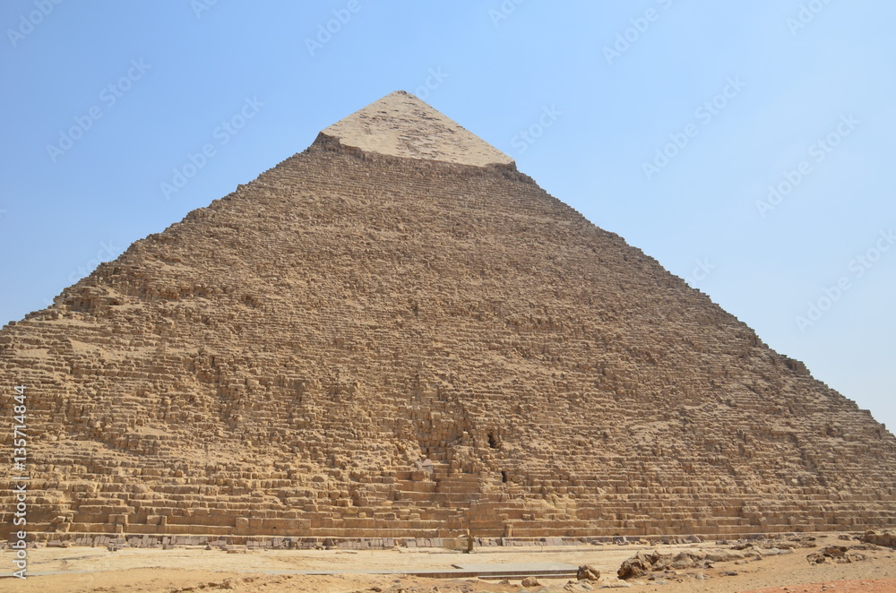 Pyramid in sand dust under gray clouds Pyramid in sand dust under gray clouds