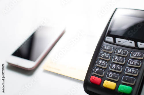 Mobile phone, credit card and pos terminal are isolated on white background.