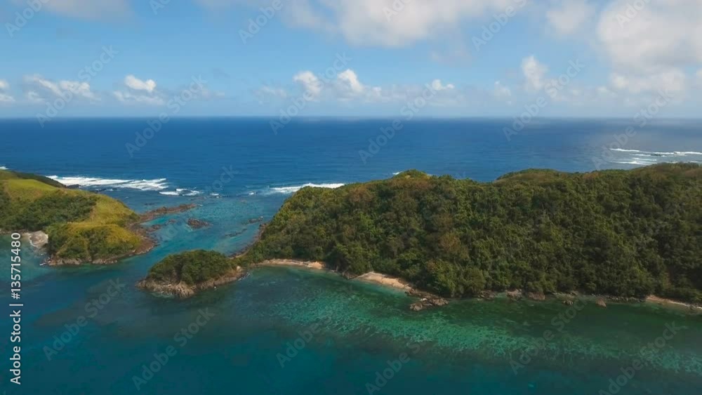Aerial view:Tropical island with beach, mountains and the rainforest. Sea and the tropical island with rocks, beach and waves. Seascape: sky, clouds, rocks, ocean. 4K video. 4K video. Travel concept Aerial view:Tropical island with beach, mountains and the rainforest. Sea and the tropical island with rocks, beach and waves. Seascape: sky, clouds, rocks, ocean. 4K video. 4K video. Travel concept