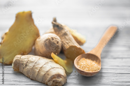 still life of fresh ginger with a wooden spoon sugar