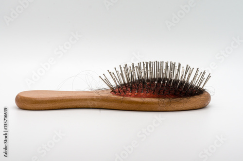 Comb and hair fall isolated on white background.
