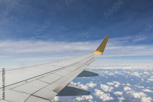 Looking at the wings during flight on airspace of Thailand.