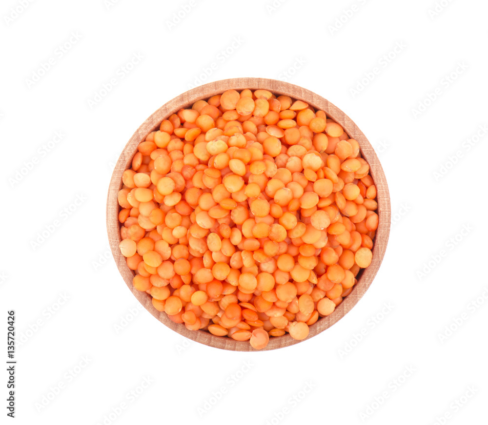 Lentils in wooden bowl isolated on white background, top view Lentils in wooden bowl isolated on white background, top view