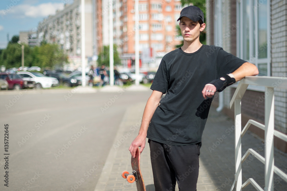 Teenage skateboarder standing