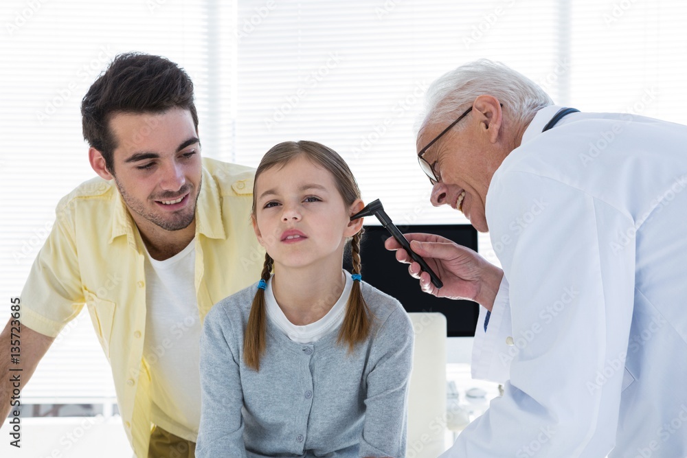 Fototapeta premium Doctor examining the ear of patient