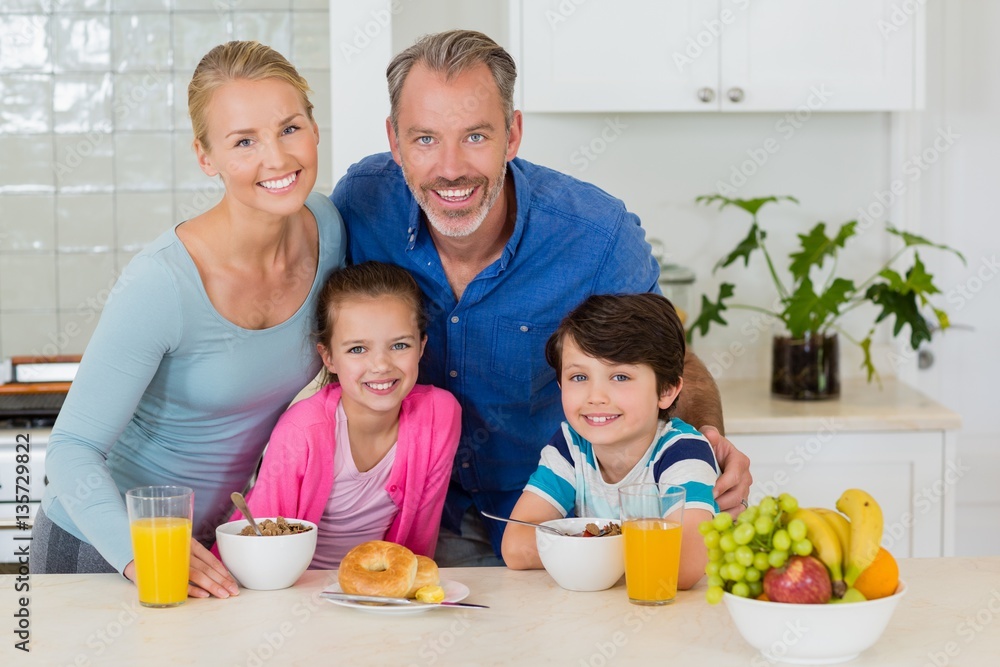 Happy family having breakfast in kitchen Happy family having breakfast in kitchen