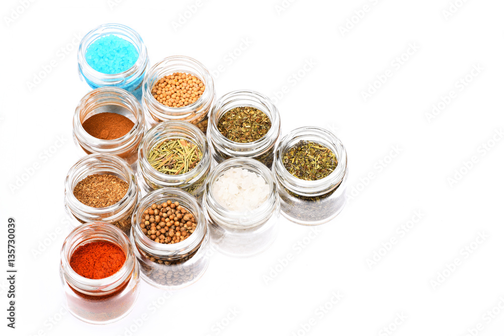 various spices in jars on white background