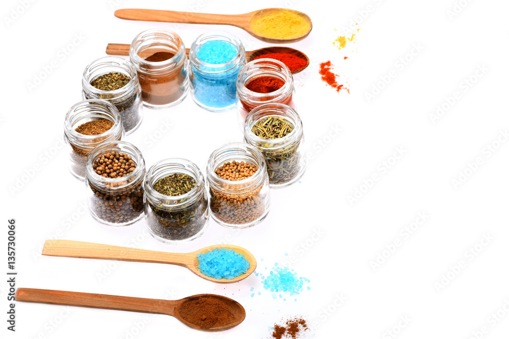 Fototapeta premium various spices in spoons and jars on white background