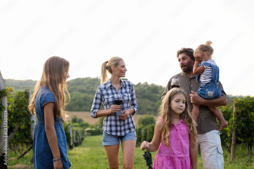 Fototapeta premium Wine grower family in vineyard before harvesting
