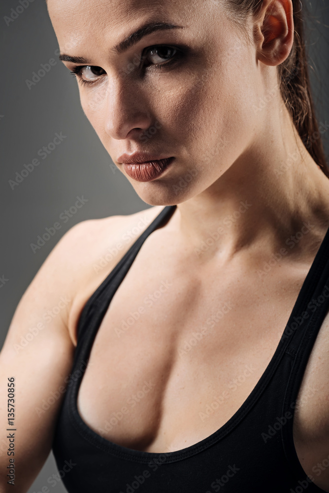 Naklejka premium Portrait of active woman posing on grey background