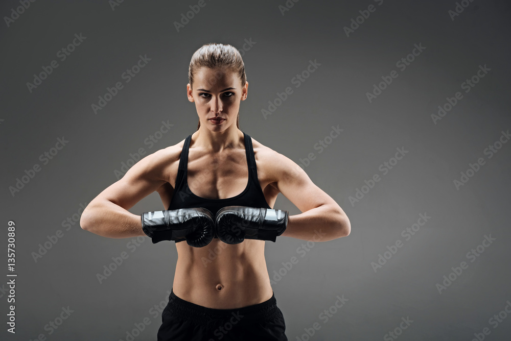 Powerful woman posing with boxing gloves Powerful woman posing with boxing gloves
