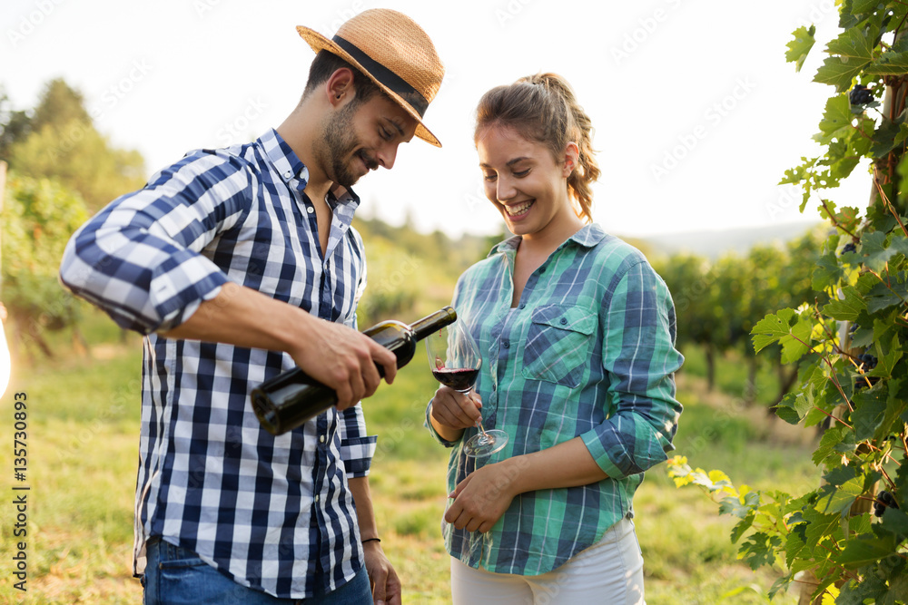 People tasting wine in vineyard People tasting wine in vineyard