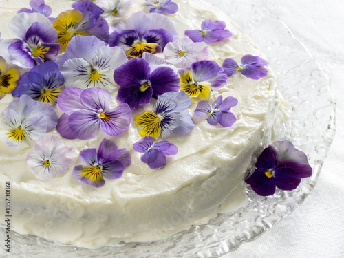 Carrot cake, decorated with edible flowers pansies
