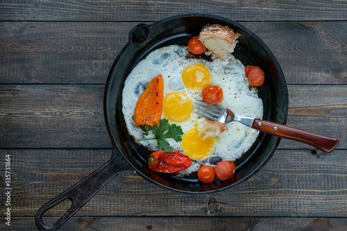 Fried eggs sunny side up in a frying pan