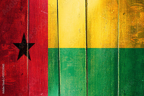 Vintage Guinea bissau  flag on grunge wooden panel photo