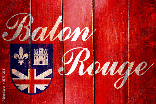 Vintage Baton rouge flag on grunge wooden panel