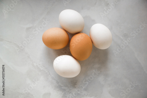 white and brown eggs on a white marble table