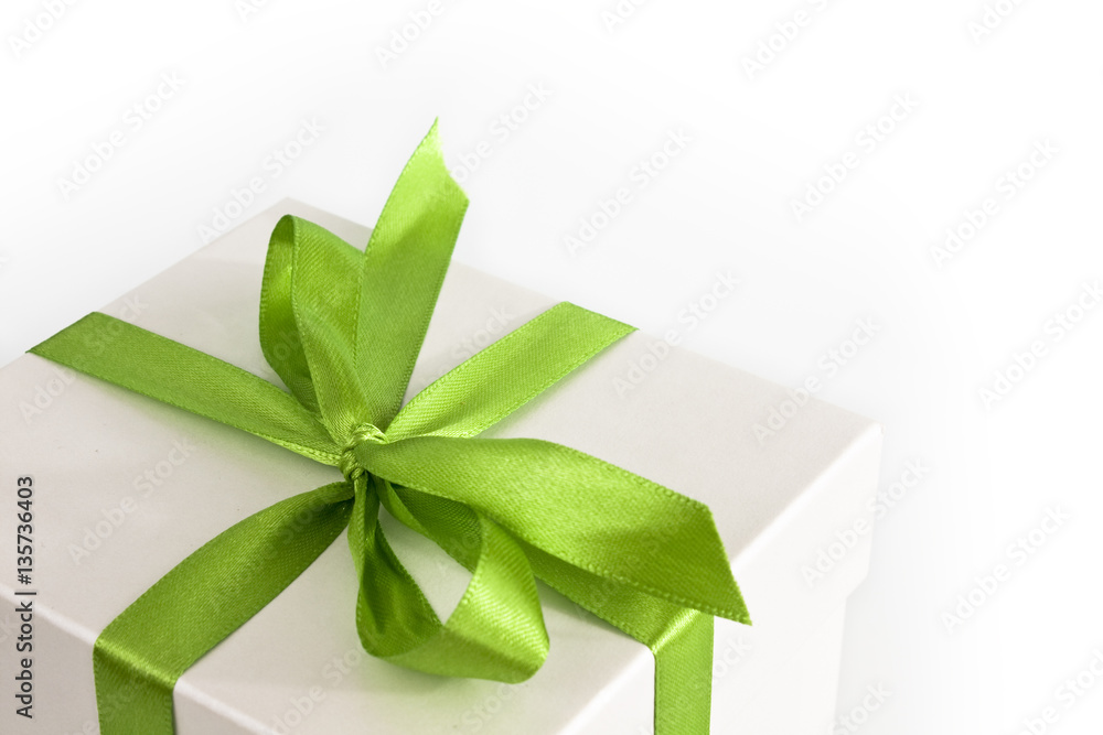 White gift box with green ribbon and bow, isolated on white background with copy space. Picture taken in studio with soft-box. White gift box with green ribbon and bow, isolated on white background with copy space. Picture taken in studio with soft-box.
