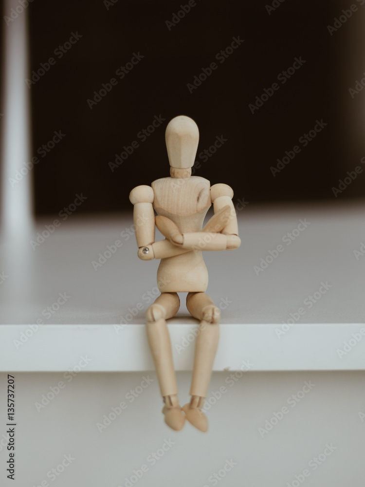Wooden Man - Lonely figure sitting alone Wooden Man - Lonely figure sitting alone