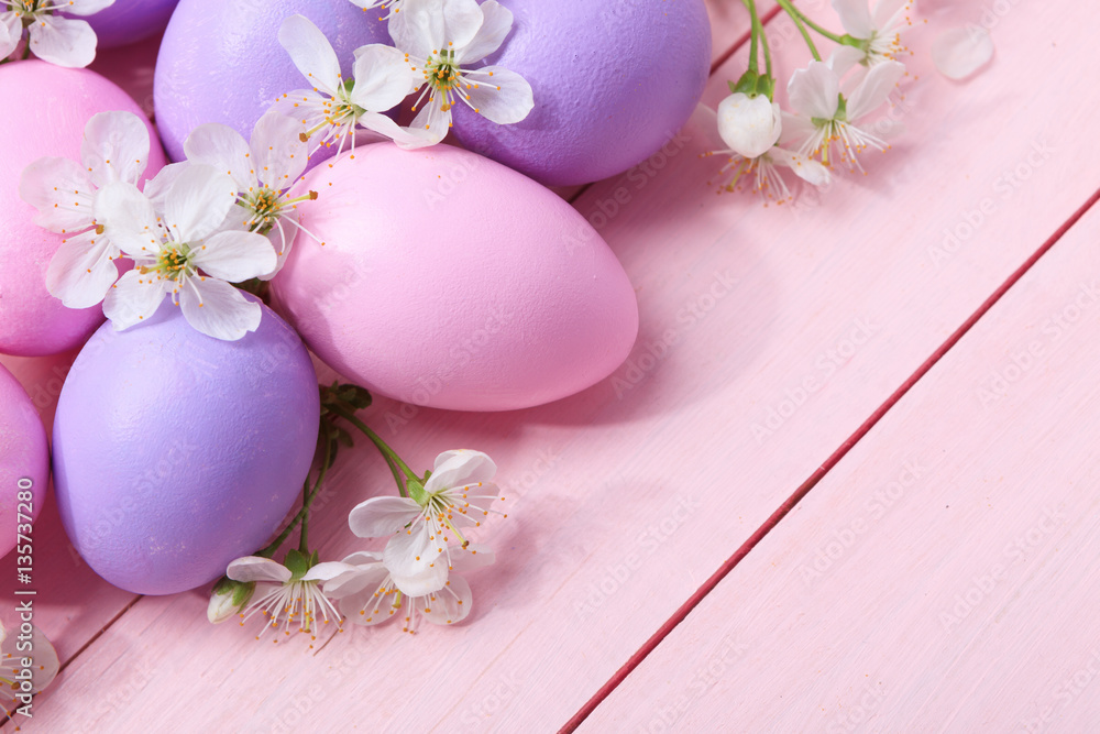 Easter eggs and white flowers on pink wooden table. Easter eggs and white flowers on pink wooden table.