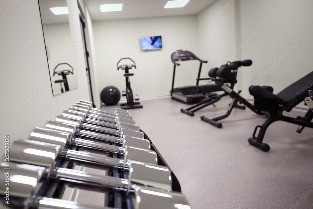 Fototapeta premium Gym equipped with weights and machines