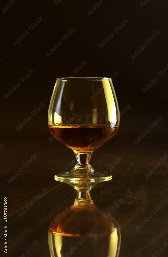 Glasses with white wine and cognac or whisky on mirror table. Celebrities composition. Glasses with white wine and cognac or whisky on mirror table. Celebrities composition.